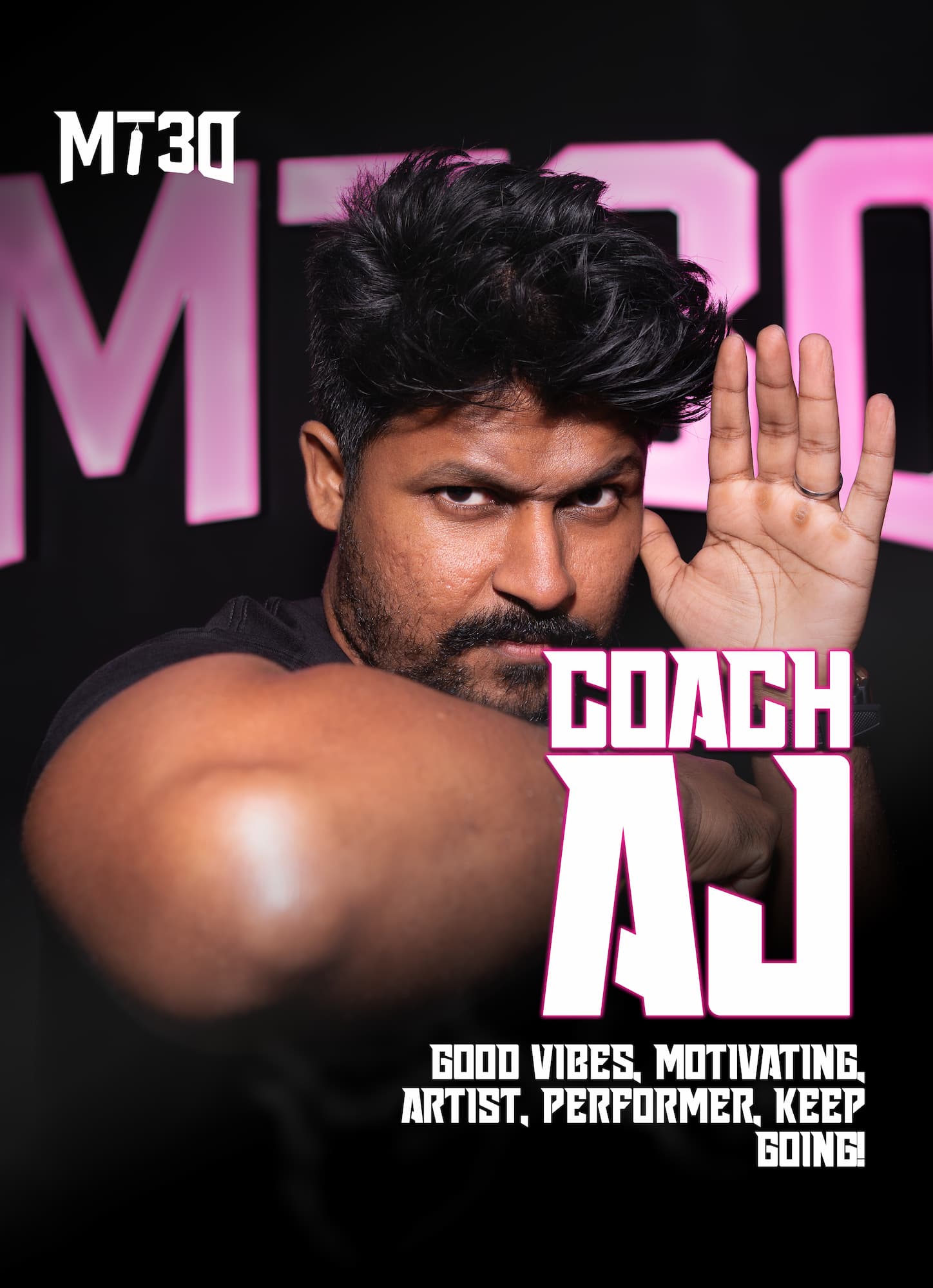 AJ, MT30 trainer, standing with arms crossed in front of the MT30 training wall