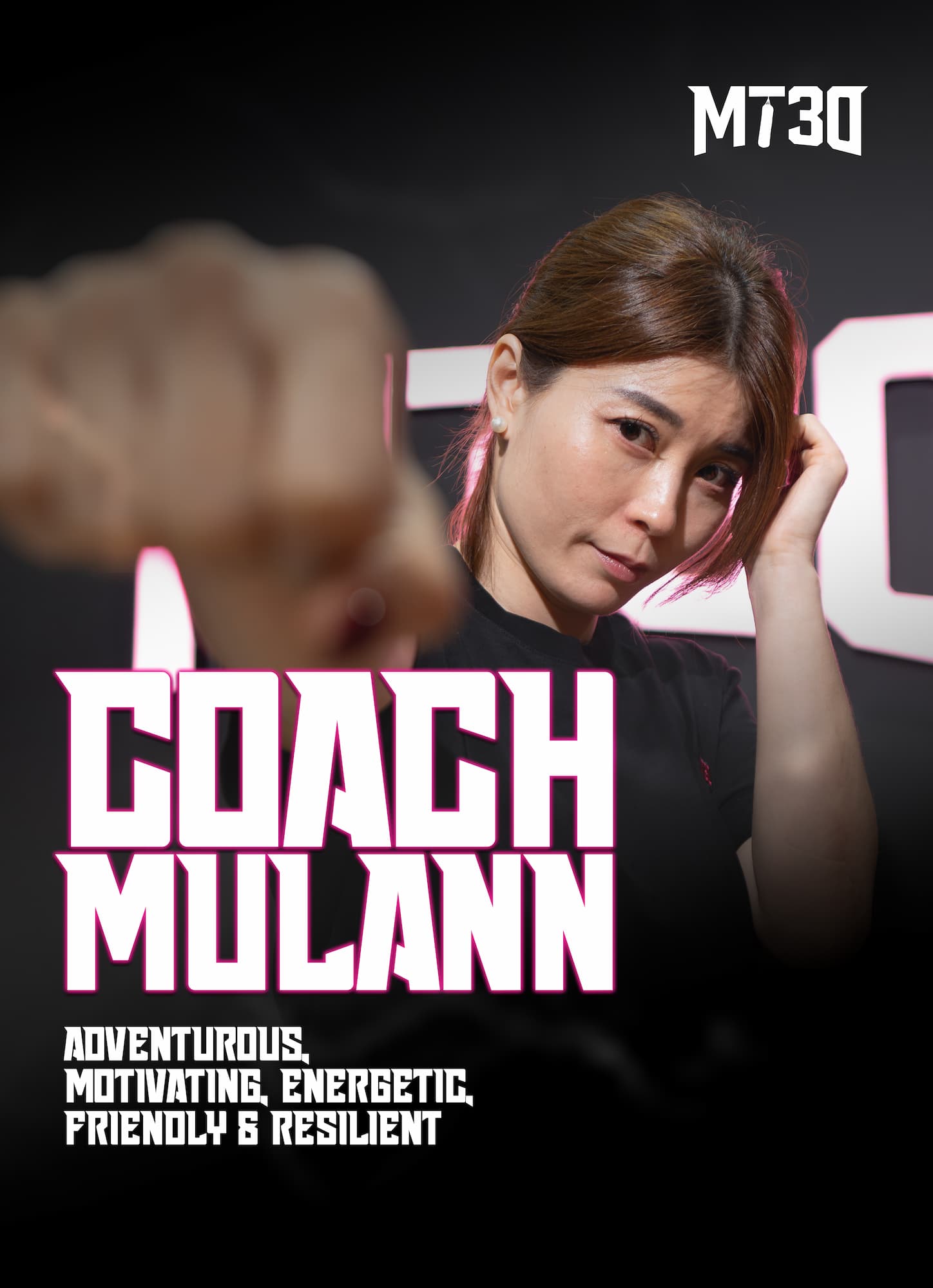 Mulann, MT30 trainer, standing confidently in front of the MT30 logo
